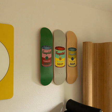 Set of 8 Colored Campbell's Soup by Andy Warhol displayed as skateboard art pieces with pop art style in a modern interior setting