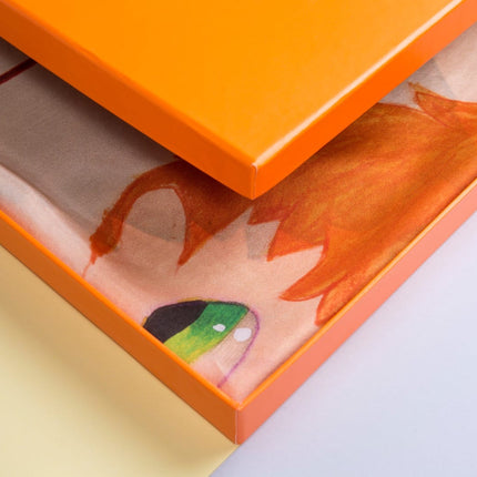 Close-up of the “Rules” design object by Javier Calleja showing vibrant colors and partial orange frame on cream background.