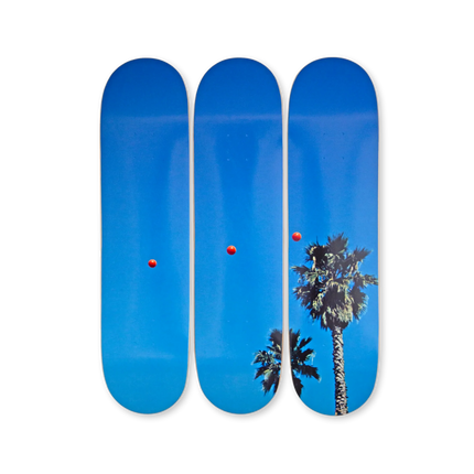 Complete view of "Throwing Three Balls in the Air to get a Straight Line (Best of Thirty-Six Attempts)" by John Baldessari on skateboard decks showing red balls and palm trees.