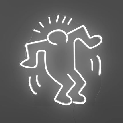 Keith Haring’s “Dancing Man YP x Keith Haring” neon lamp artwork glowing in white light against a gray background
